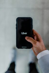 hand holding a phone showing the Uber app